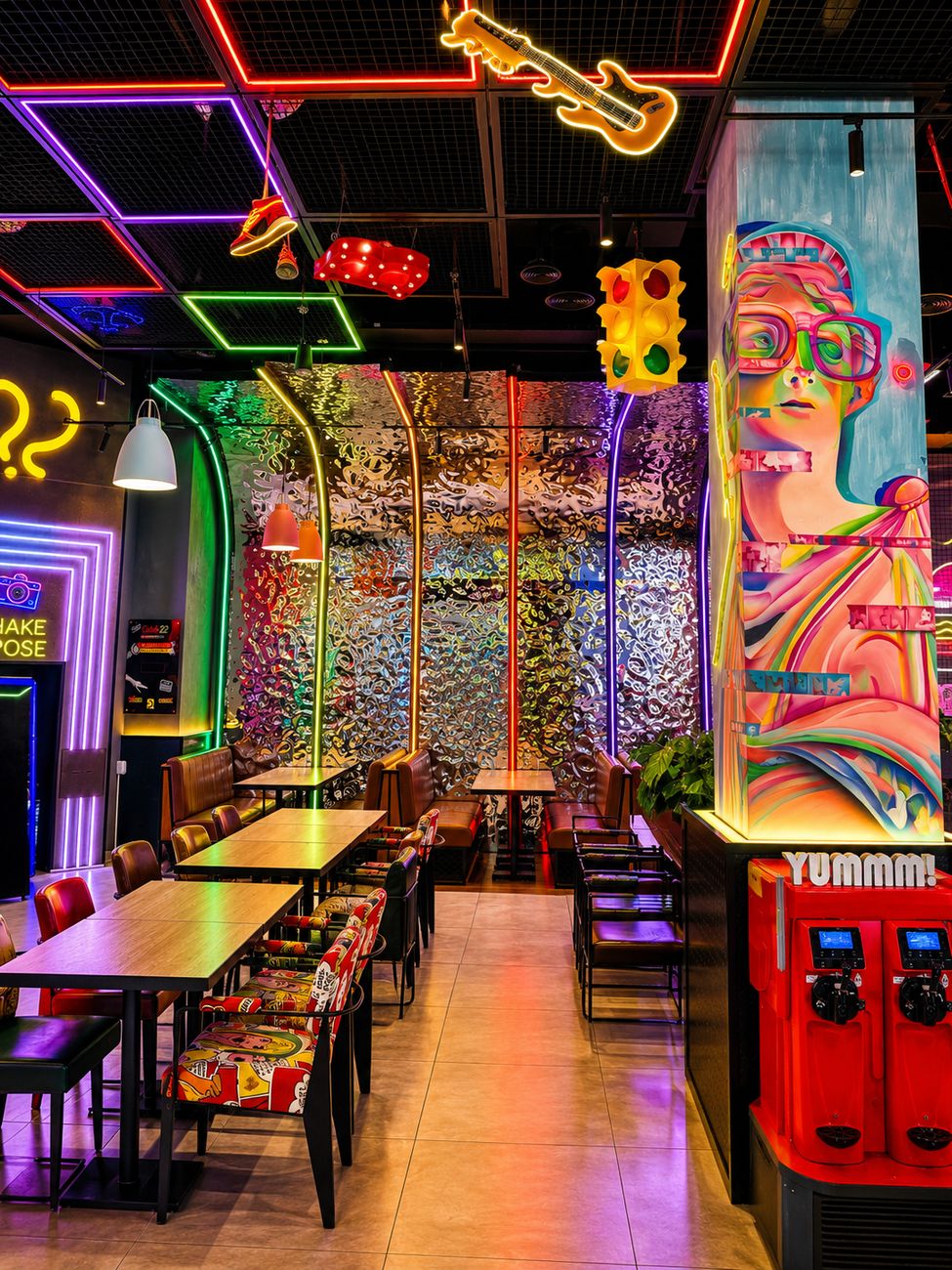 Catch 22 dining area with foil wall and pop art mural pillar, Mirdiff City Centre