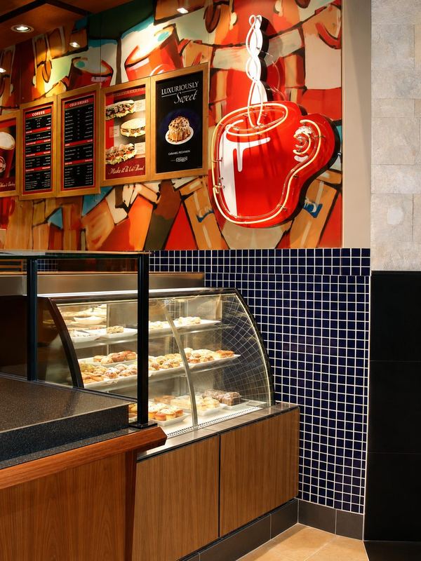 Cinnabon neon coffee cup and pastry display, by Davies Group UAE