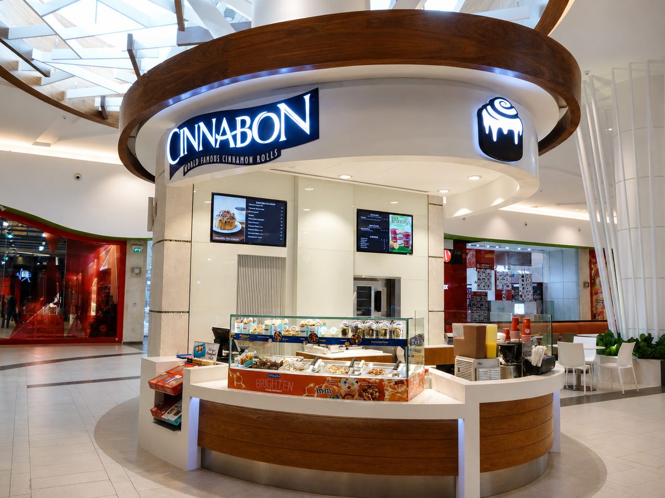 Cinnabon kiosk, full storefront wide view, mall corridor, by Davies Group UAE