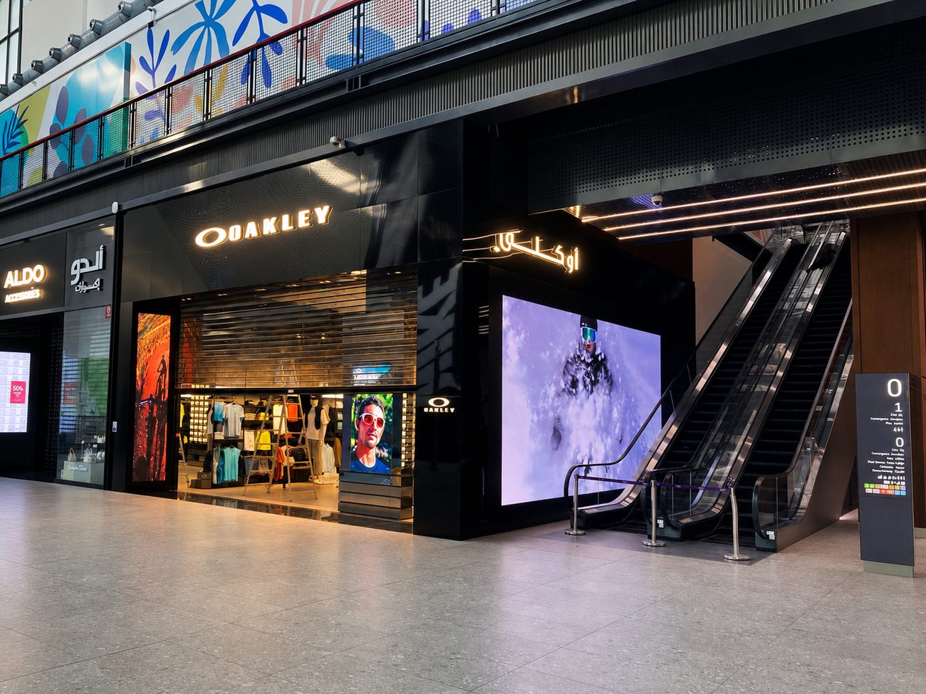 Oakley exterior storefront with LED screen beside escalator, Jeddah, Saudi Arabia