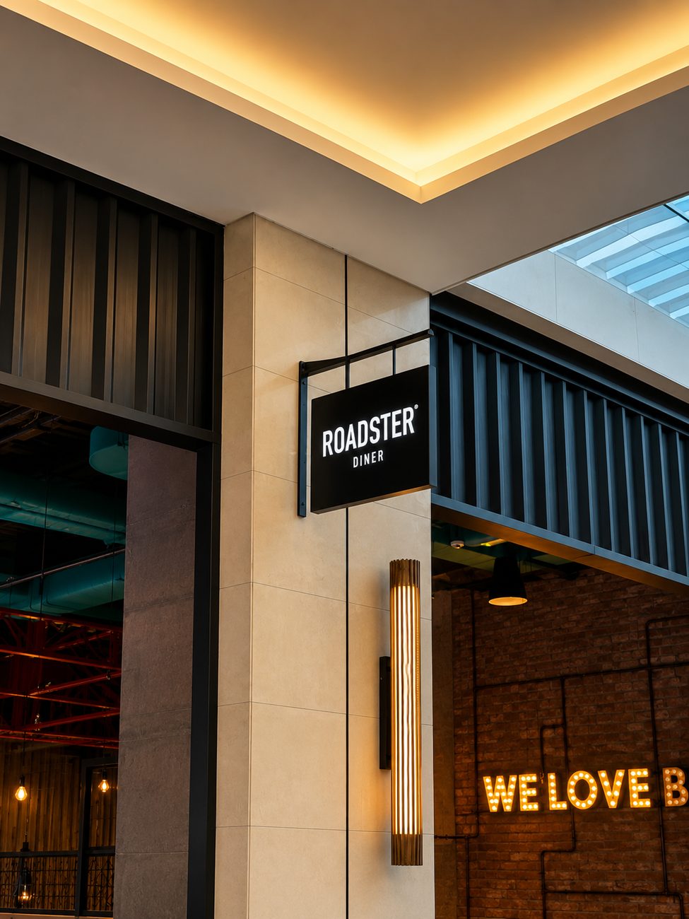 Roadster Diner pillar sign with We Love Burgers brick wall, Dubai Hills Mall