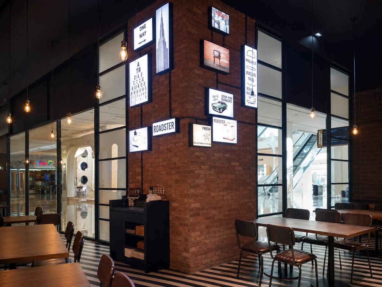 Roadster Diner brick pillar with illuminated light-box gallery, Mirdiff City Centre